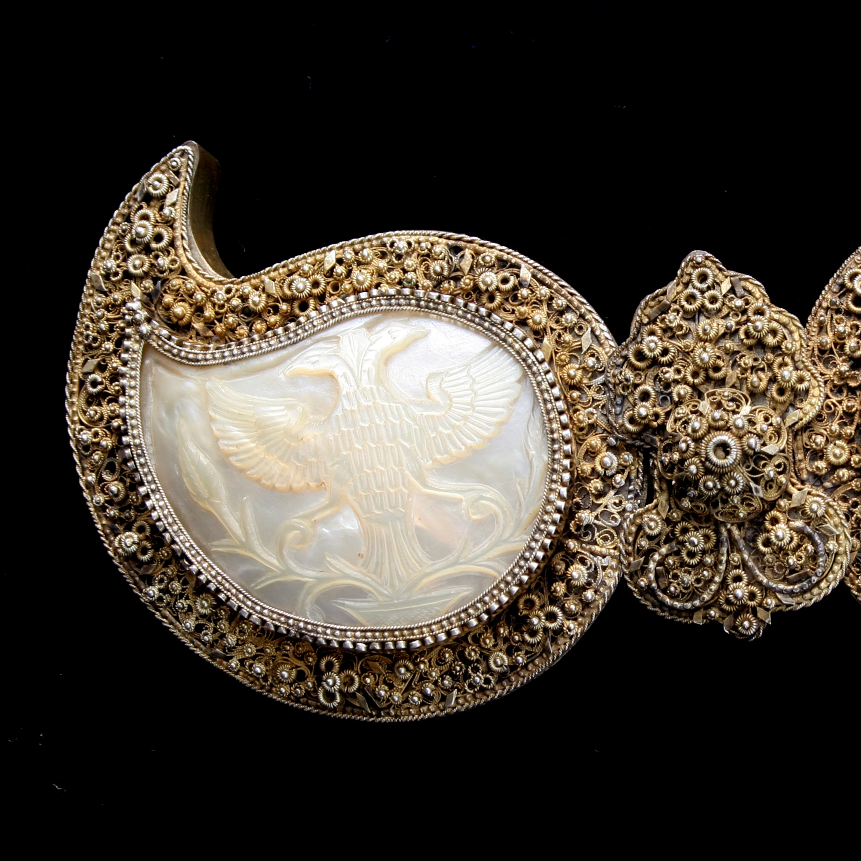Buckles, richly decorated and with a relief image of a two-headed bird.